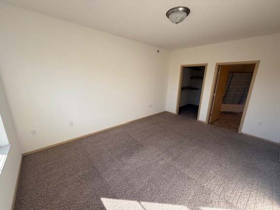 A room with a carpeted floor and a ceiling light.