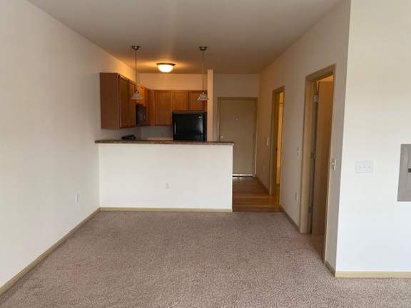 A room with a counter and a microwave.