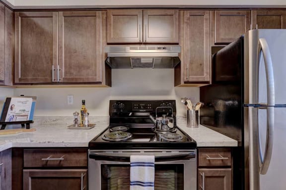 a kitchen with a stove top oven next to a refrigerator