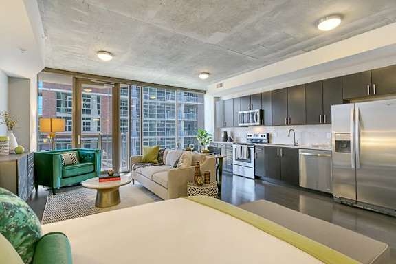 a living room with a kitchen and a couch