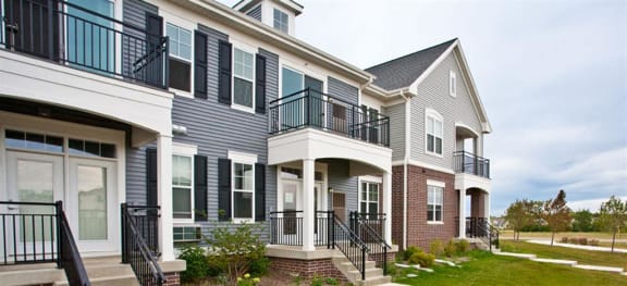 a row of houses with steps and balconies