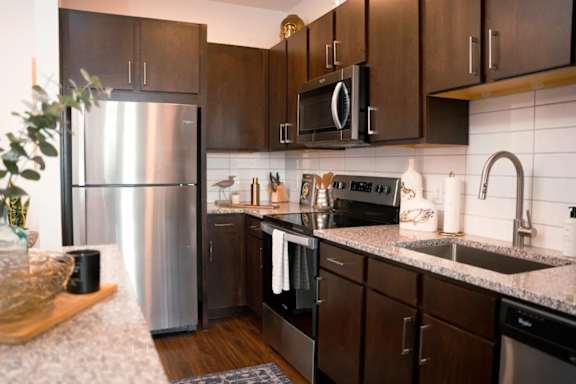 a kitchen with stainless steel appliances and granite counter tops