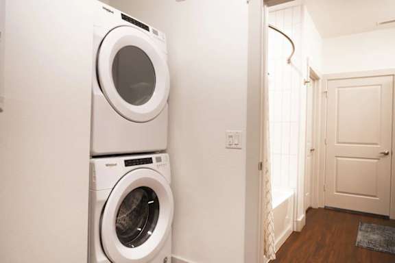 a washer and dryer in a white laundry room