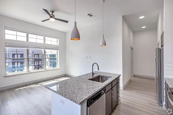 a kitchen with an island and a large window