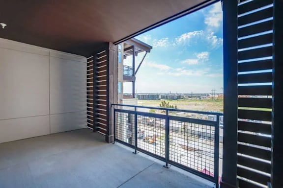 a balcony with a view of a building and the sky