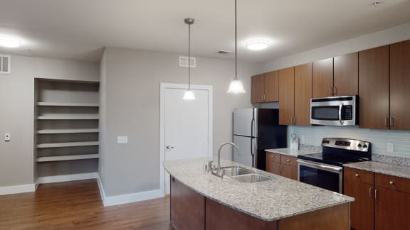 a kitchen with wooden cabinets and a granite counter top