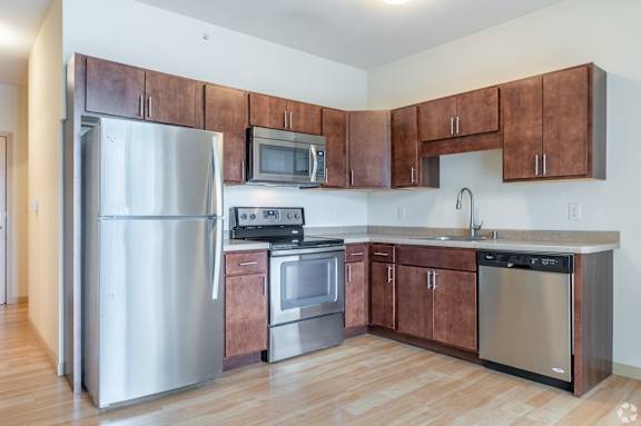 A kitchen with wooden cabinets and stainless steel appliances.