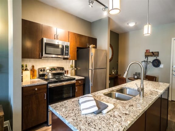 a kitchen with a granite counter top and stainless steel appliances