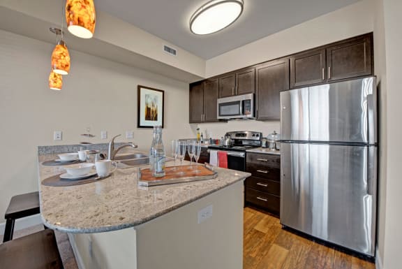 a kitchen with a large island and stainless steel appliances