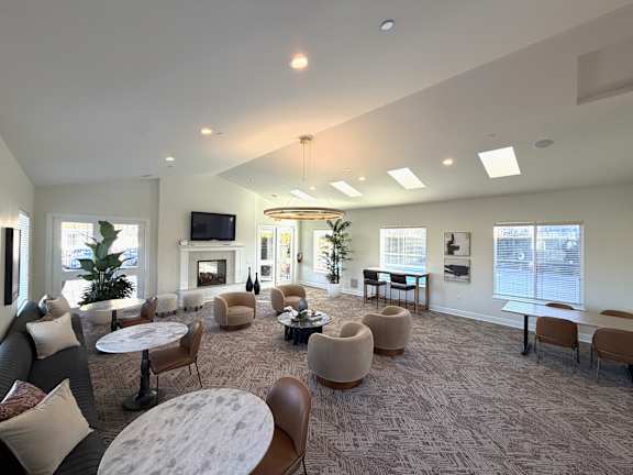 A spacious room with a fireplace and comfortable seating.