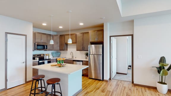 a kitchen with an island and stools
