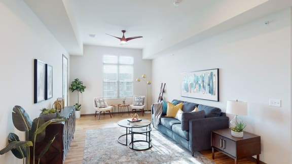 a living room with a couch and a coffee table in front of a window