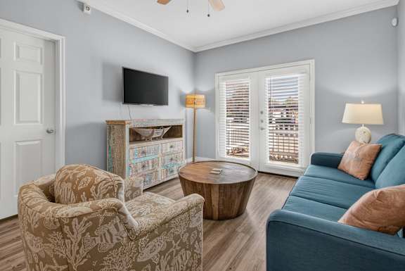 A living room with a blue couch and a television.