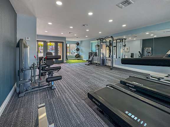 A well-equipped gym with a variety of machines and weightlifting equipment.