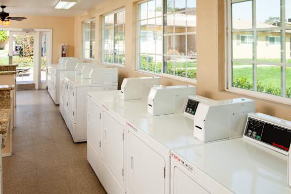 A row of washing machines in a laundromat at Country Village Apartments, Jurupa Valley, CA, 91752