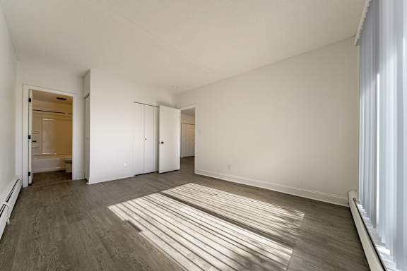 A room with a wooden floor and white walls.