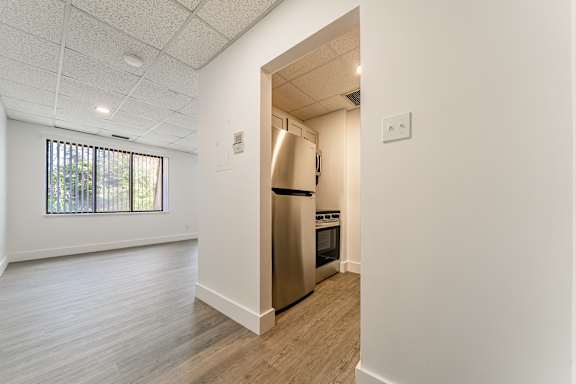 A kitchen with a refrigerator and oven is shown.