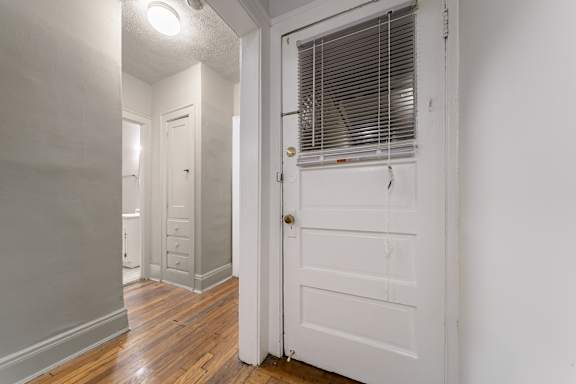 A white door with a window above it.