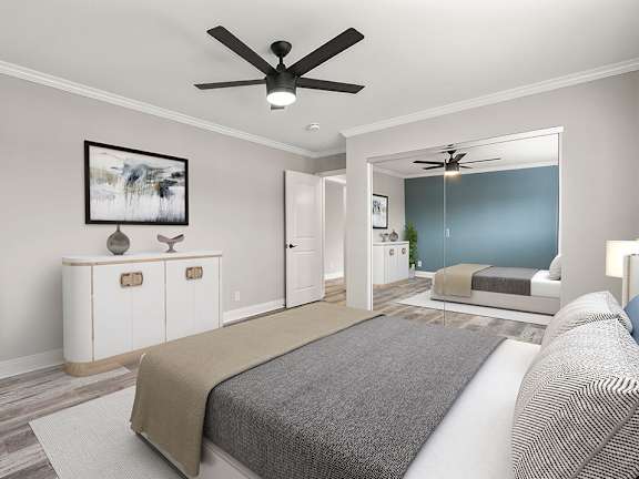 A bedroom with a bed, a ceiling fan, and a cabinet with two doors.