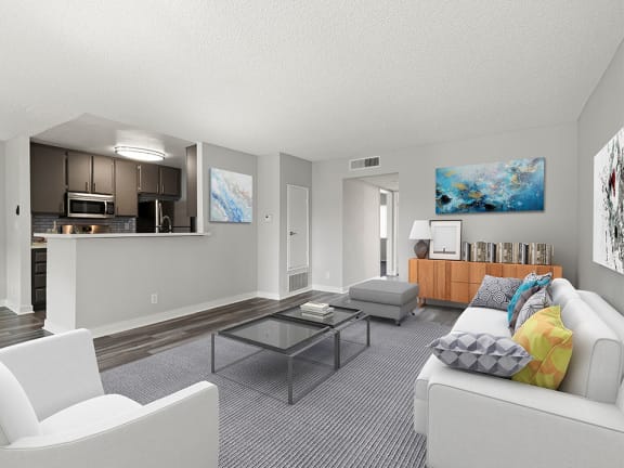 Living room with hardwood floors and view of kitchen.
