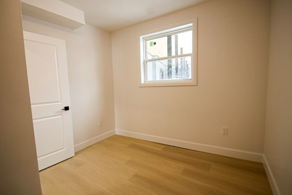 A room with a window and a door.