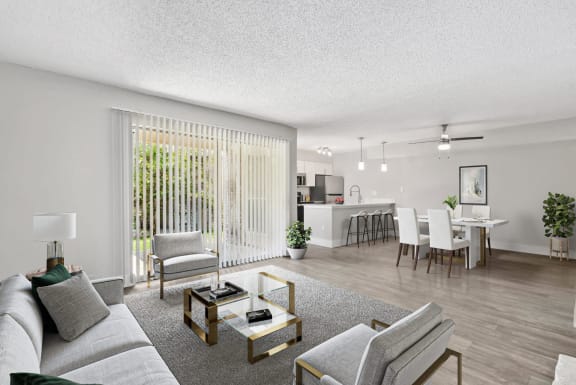 the living room of an apartment with a couch and chairs