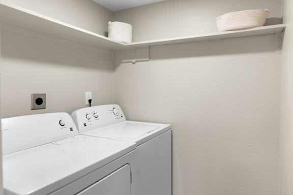 A white washing machine in a laundry room.