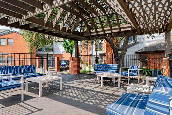 A patio with blue and white chairs and tables.