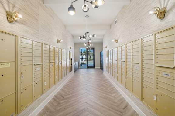 a long hallway with lockers in a room with a wood floor