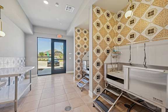a laundry room with a sink and a door to the outside