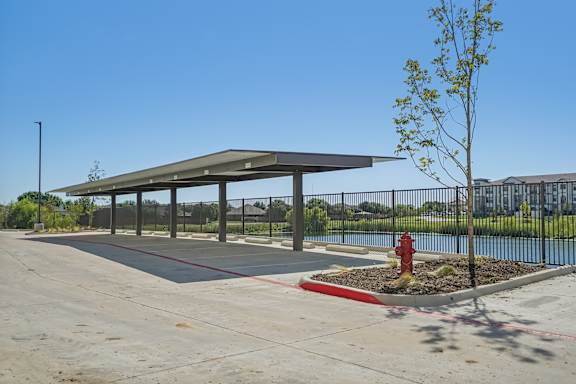 a covered parking lot with a fire hydrant