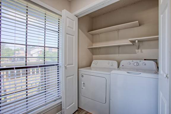 A small laundry room with a washer and dryer.