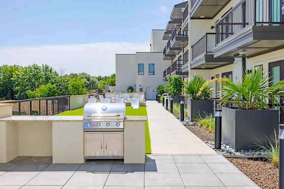 A modern outdoor kitchen with a grill and sink.