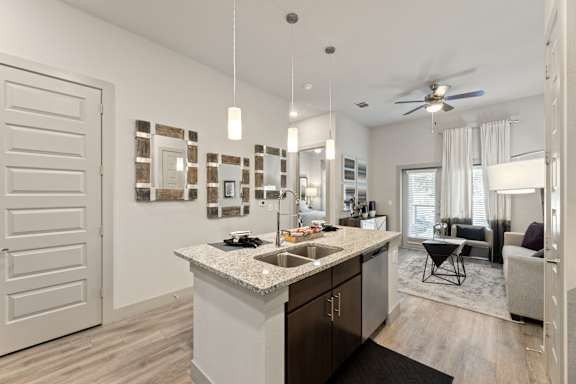 A modern kitchen with a large island and a dining area.