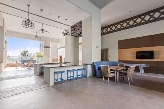 A modern open plan living and dining area with a bar.