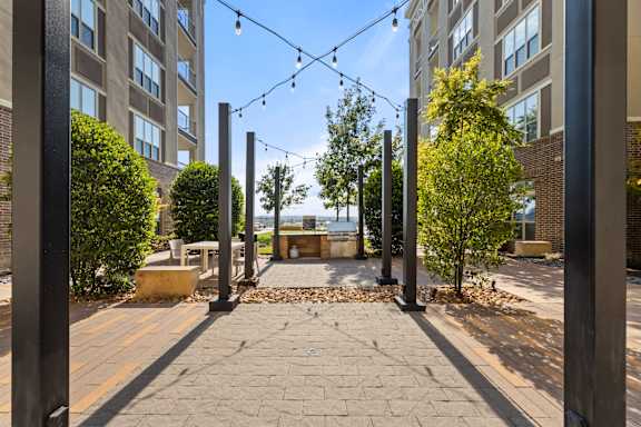 A courtyard with a bench and a tree in the middle.