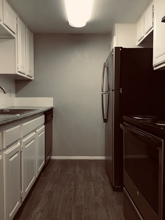 a kitchen with white cabinets and black appliances &#xA0;at 2151 Kirkwood, Houston