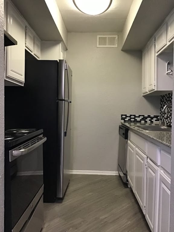 a kitchen with white cabinets &#xA0;at 2151 Kirkwood, Texas