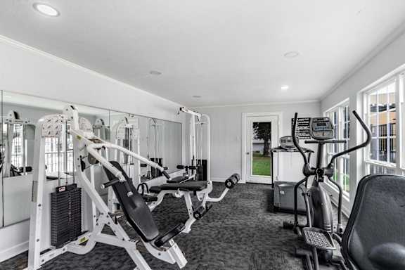 A spacious gym with a variety of exercise equipment.