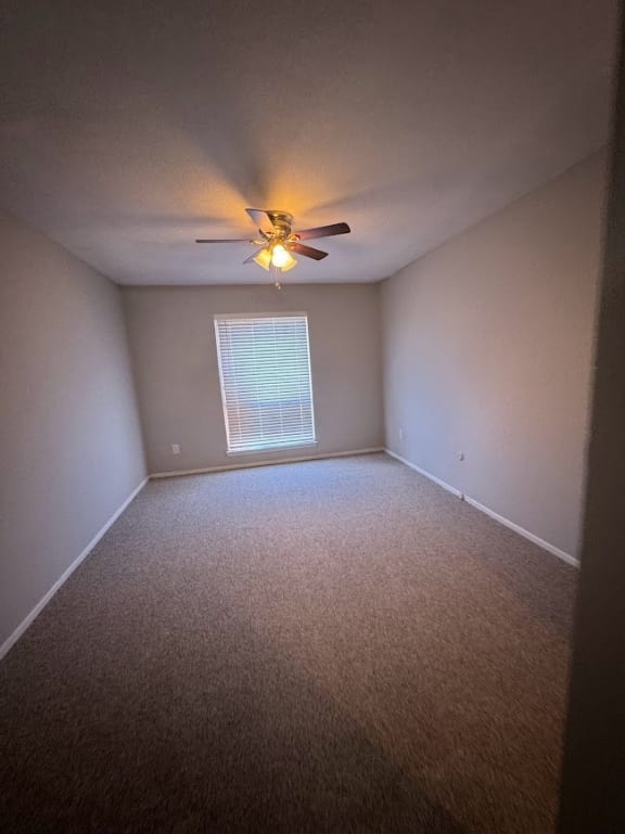 an empty room with a ceiling fan