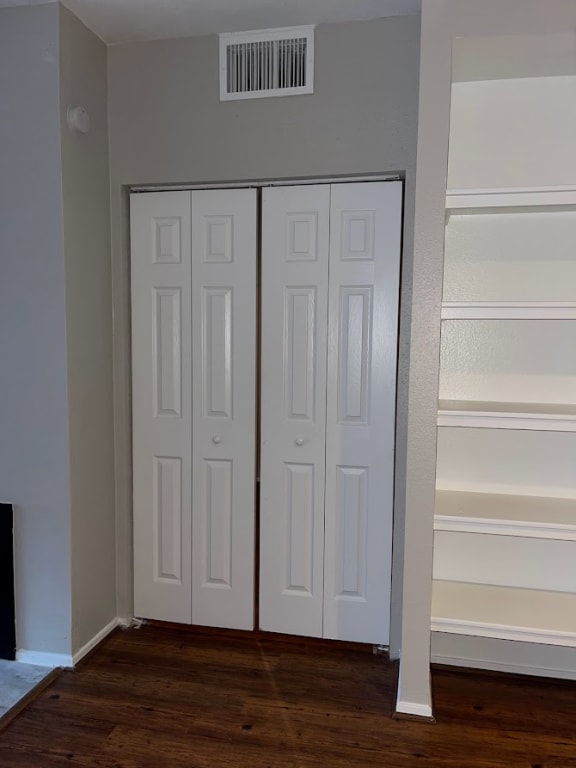 a pair of white doors in a room with a wooden floor