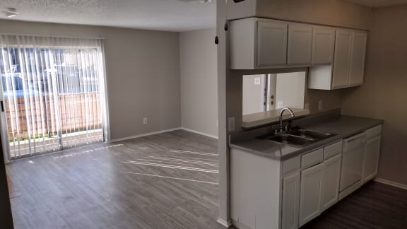 an empty kitchen and living room in an empty apartment