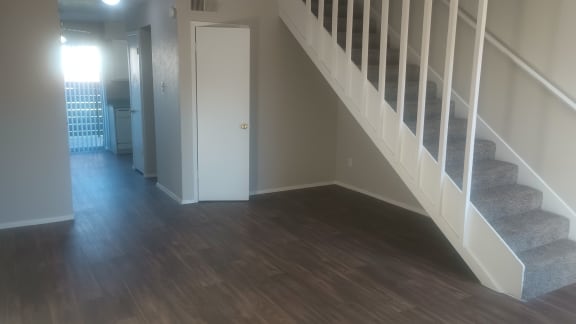 a view from the bottom of a staircase in a home with wood floors