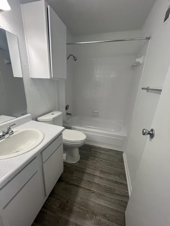 an empty bathroom with a sink toilet and bath tub