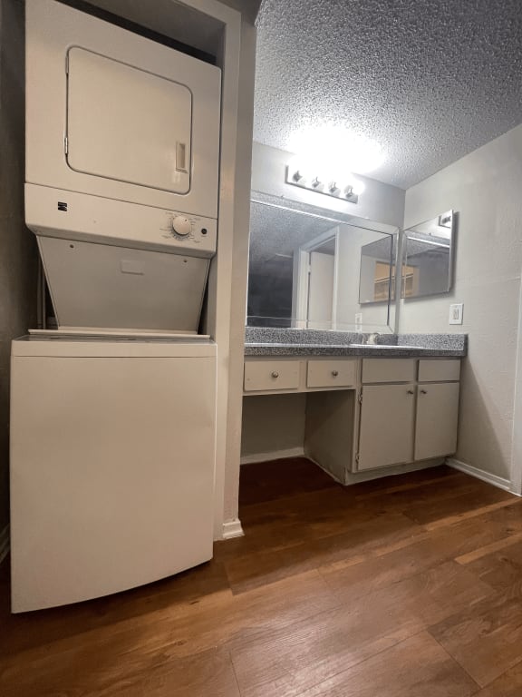 an empty bathroom with a washer and dryer in it