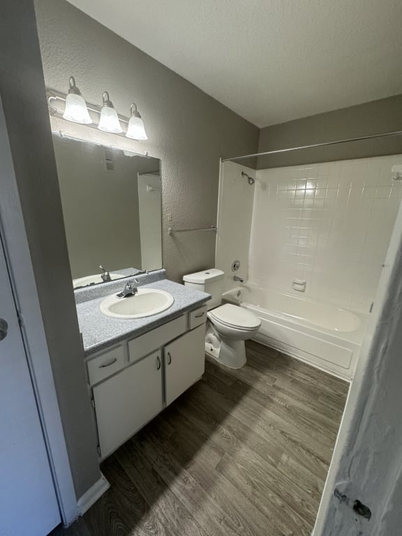 an empty bathroom with a sink toilet and shower
