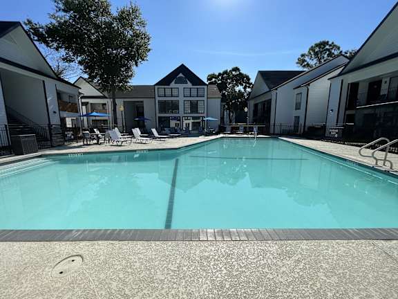 Large outdoor swimming pool with surrounding deck at 2151 Kirkwood Apartments, Houston, TX