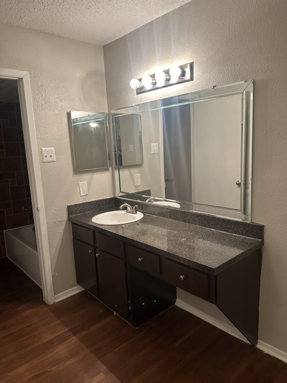 an empty bathroom with a sink and a mirror