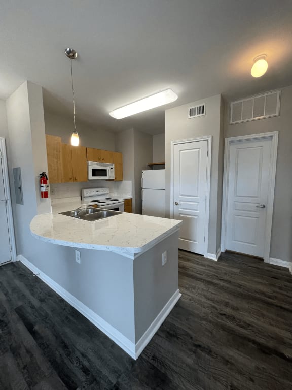 a kitchen with an island and a stove and a microwave