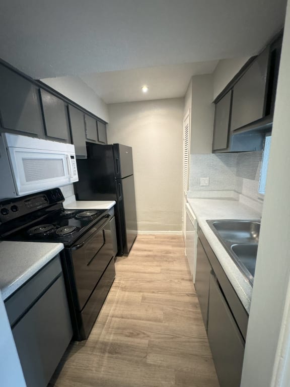 a kitchen with stainless steel appliances and black and white appliances
